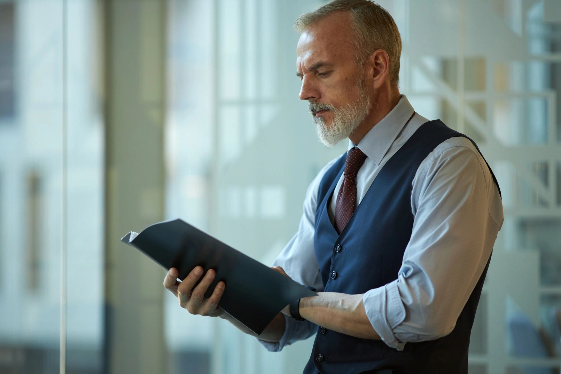 Property owner reviewing management documents in an office